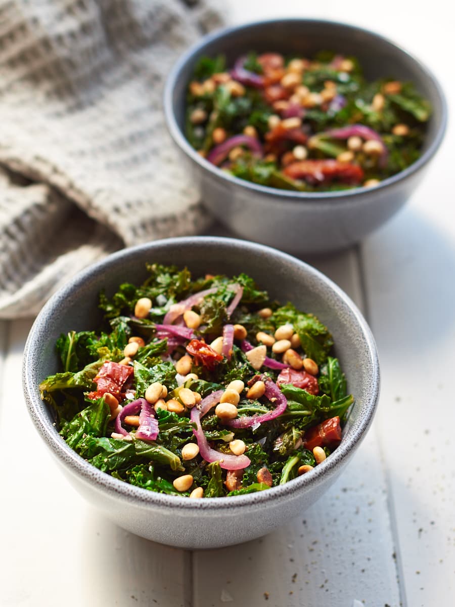 Sauteed Kale with Garlic and Toasted Pine Nuts in bowls