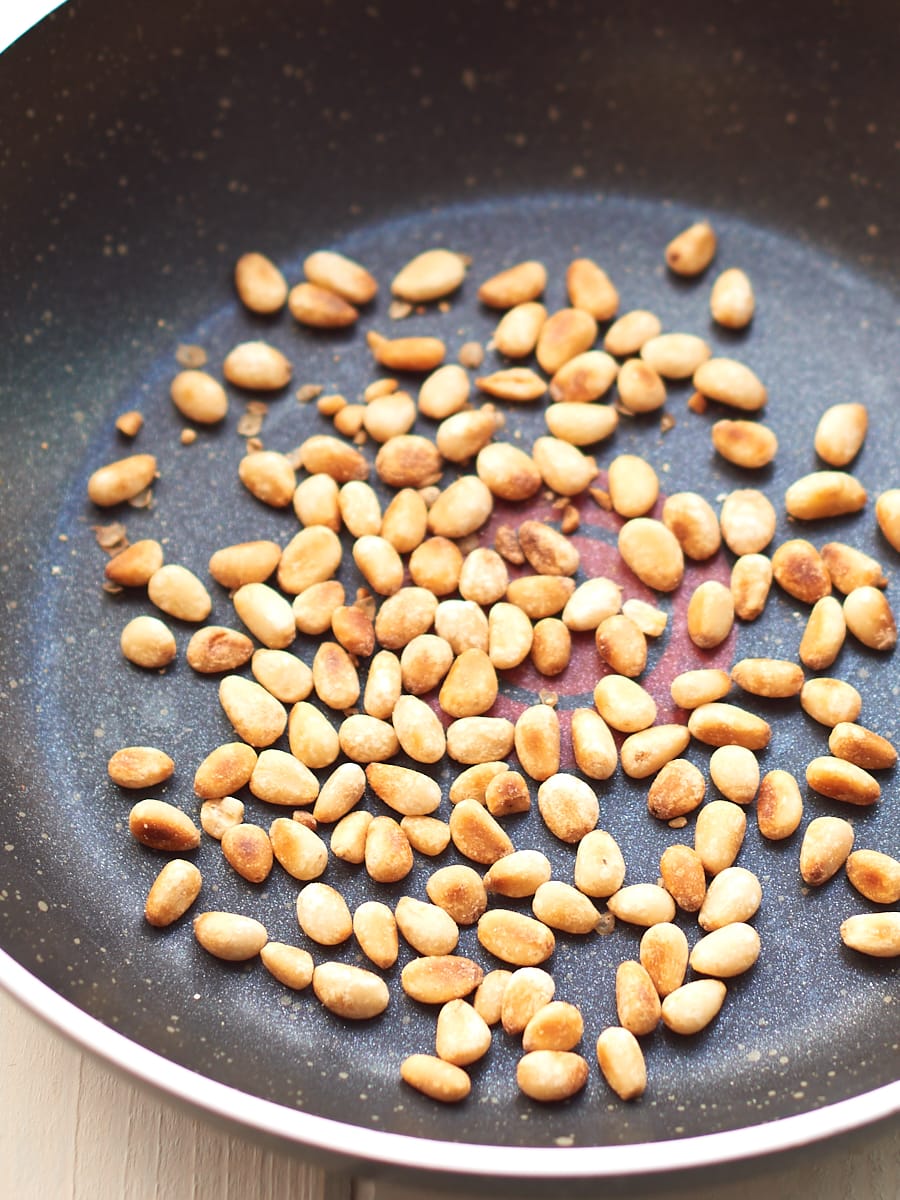 Toasted pine nuts in pan