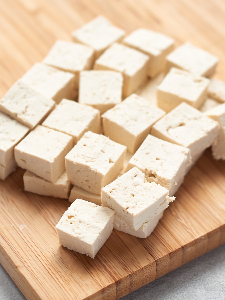 Cubed tofu on chopping board