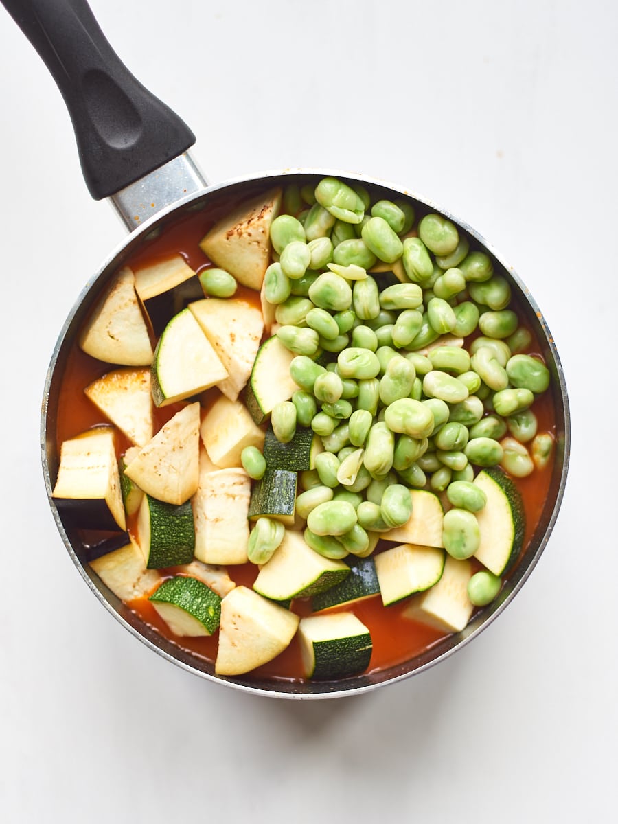 Adding broad beans and courgettes to soup