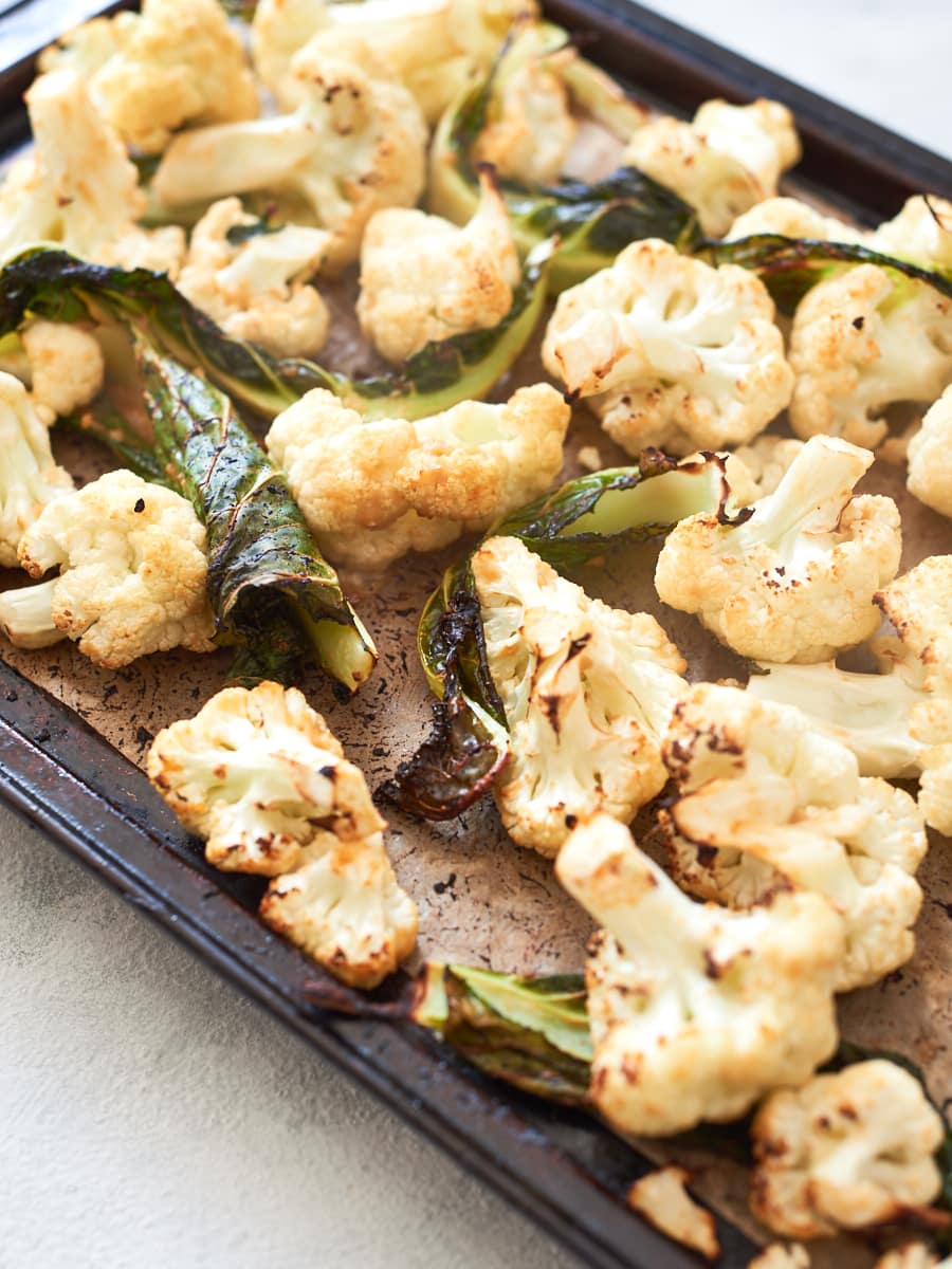 roasted cauliflower and leaves on tray