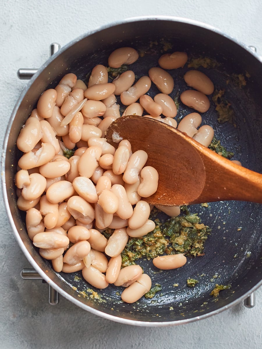 adding cannellini beans to pan
