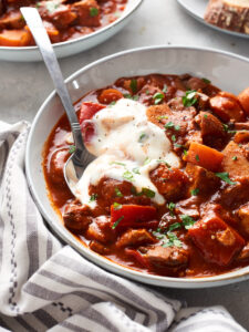vegan goulash in bowl with yoghurt