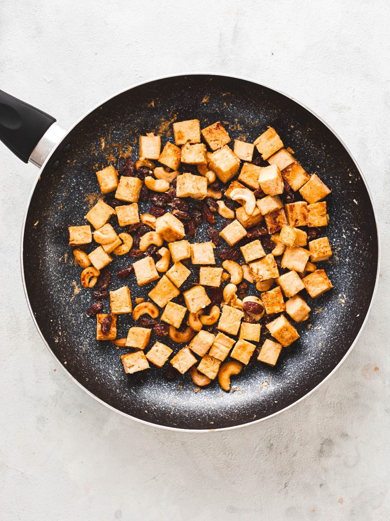 Paste browned off in the pan with tofu, cashews and raisins