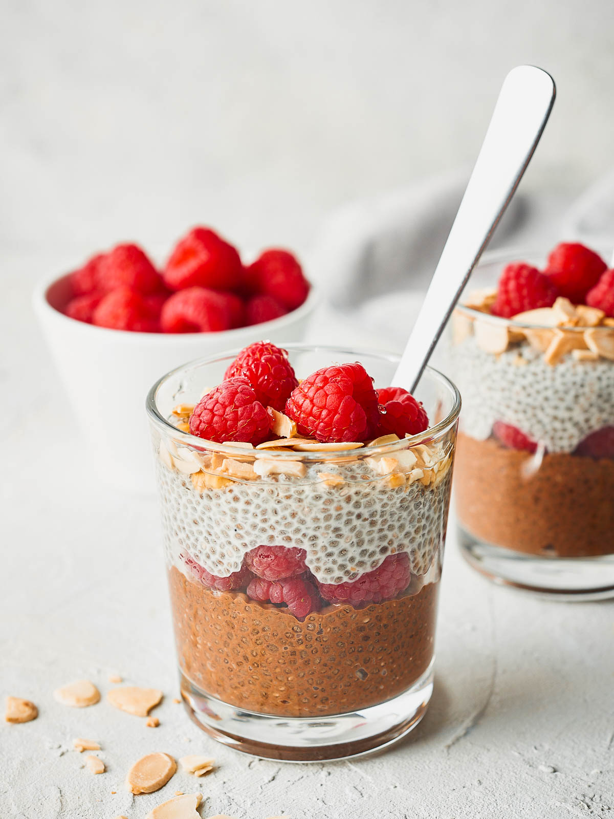 Chia seed parfait in a jar with a spoon coming out of it