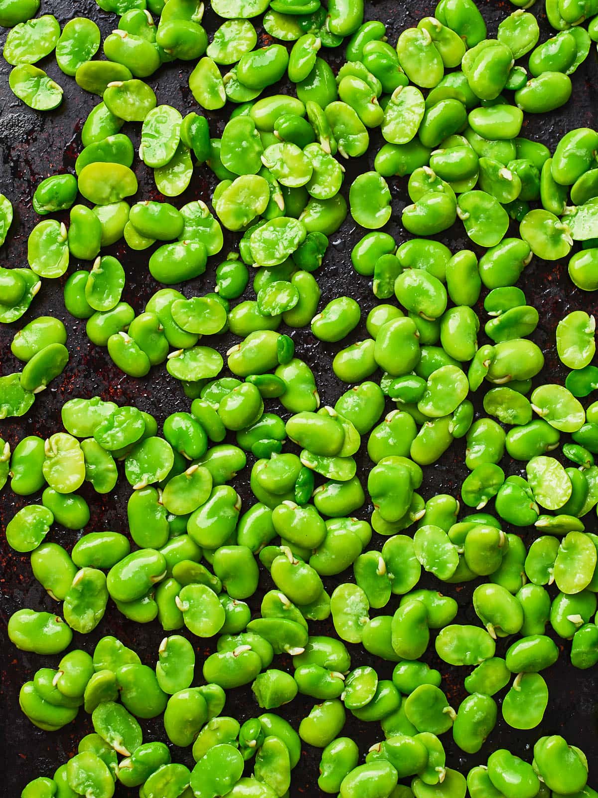 Broad beans on a baking tray