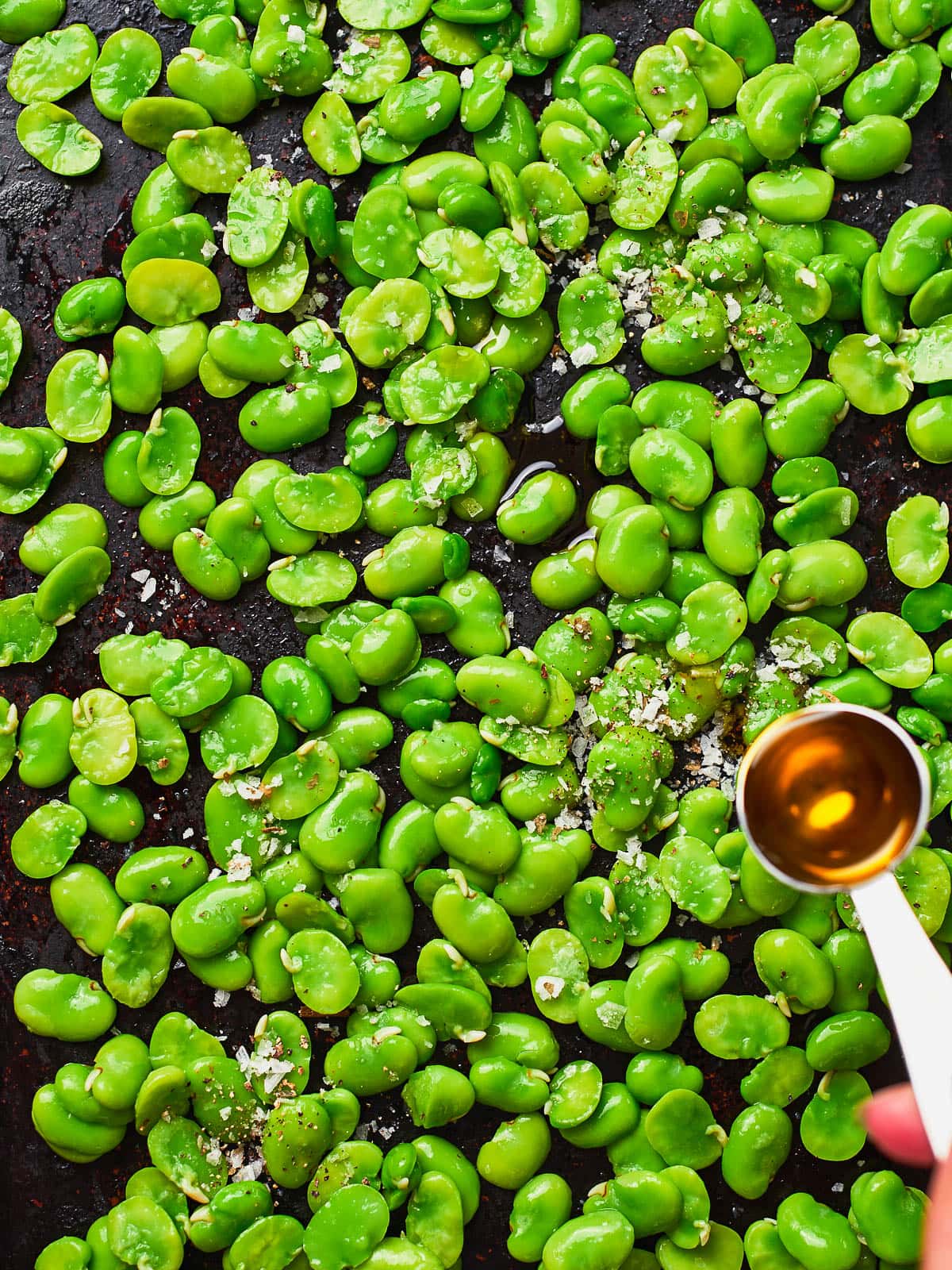Adding oil to broad beans