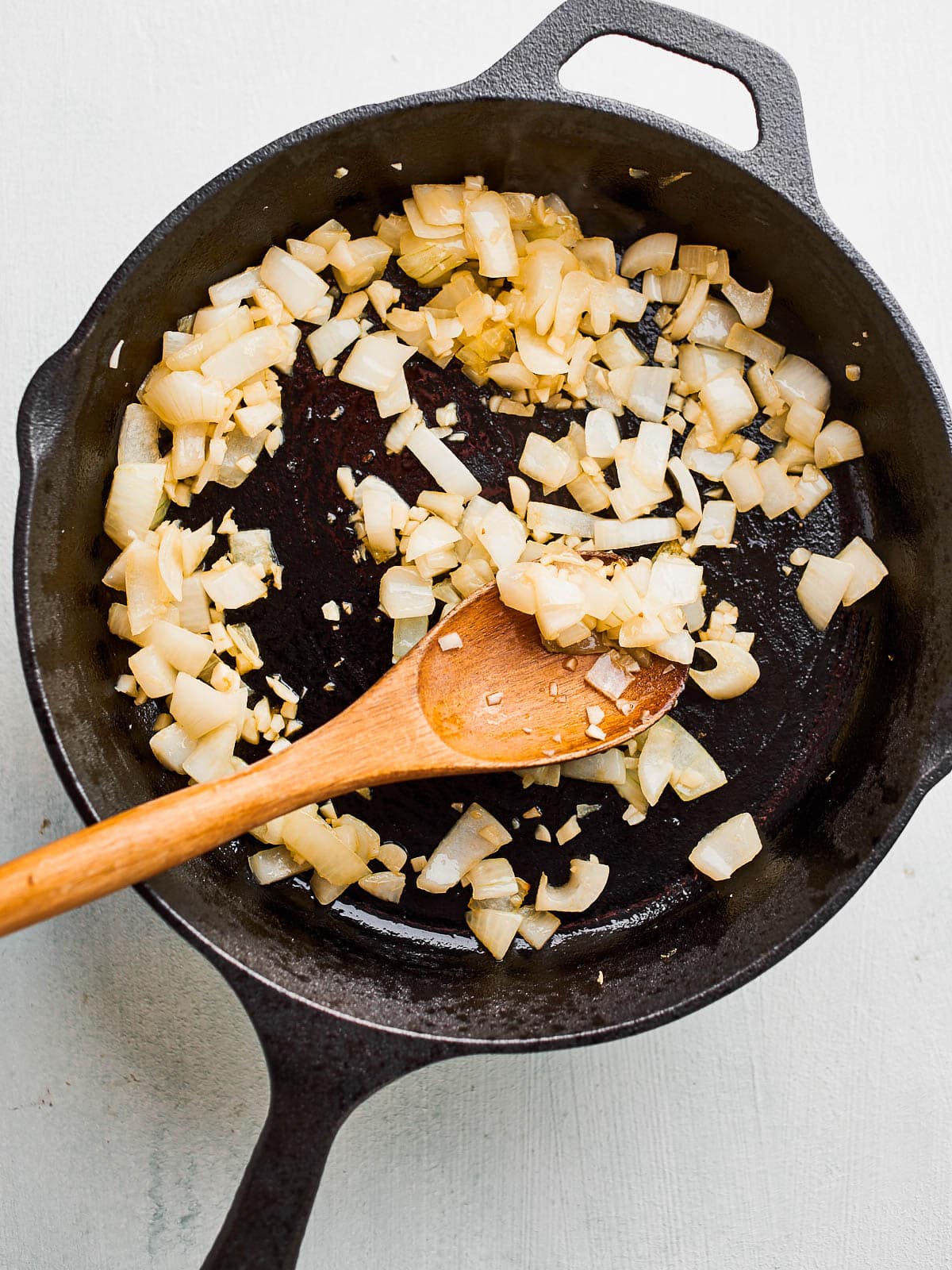 frying onion and garlic in a skillet