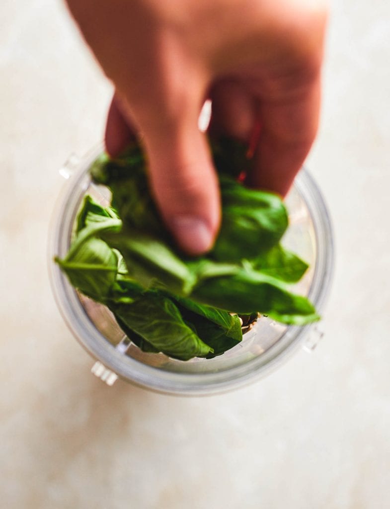 adding spinach to the blender