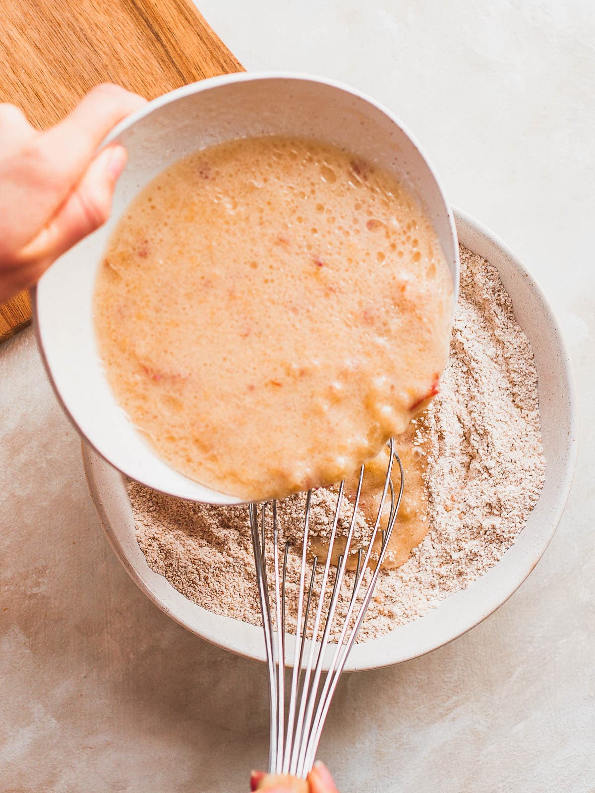 Wet ingredients being poured into dry ingredients