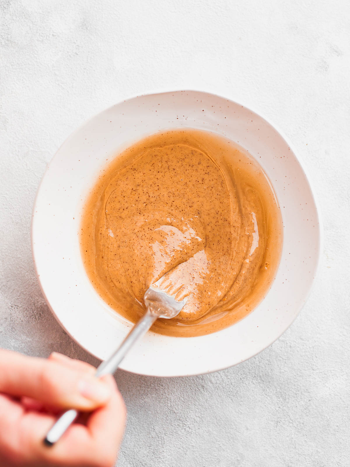 Whisking the peanut butter with the coconut oil