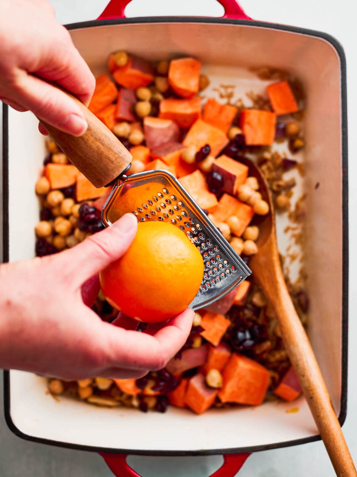 Adding orange zest to the pan