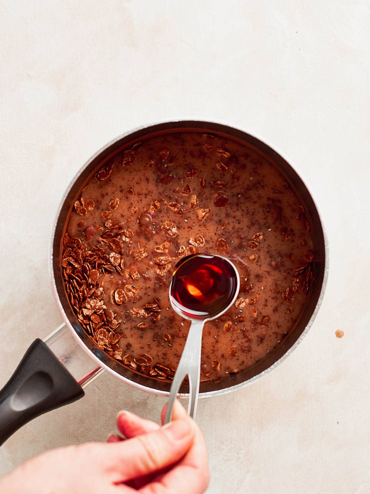 Maple syrup being added to pan