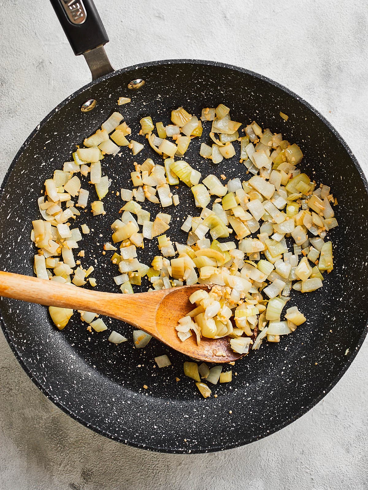 Frying onion and garlic in a frying pan