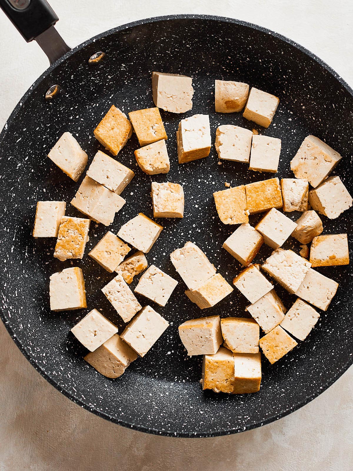 Tofu in pan beginning to go golden