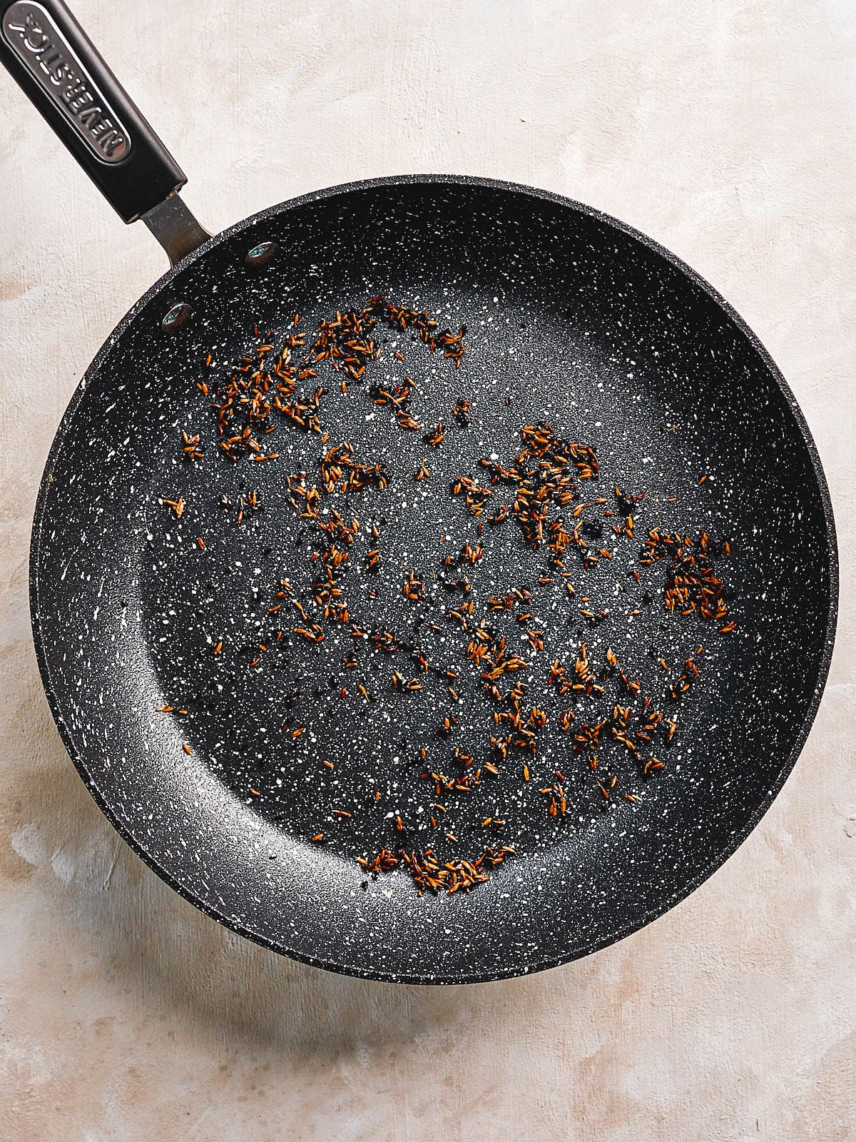 Frying off whole spices in a frying pan