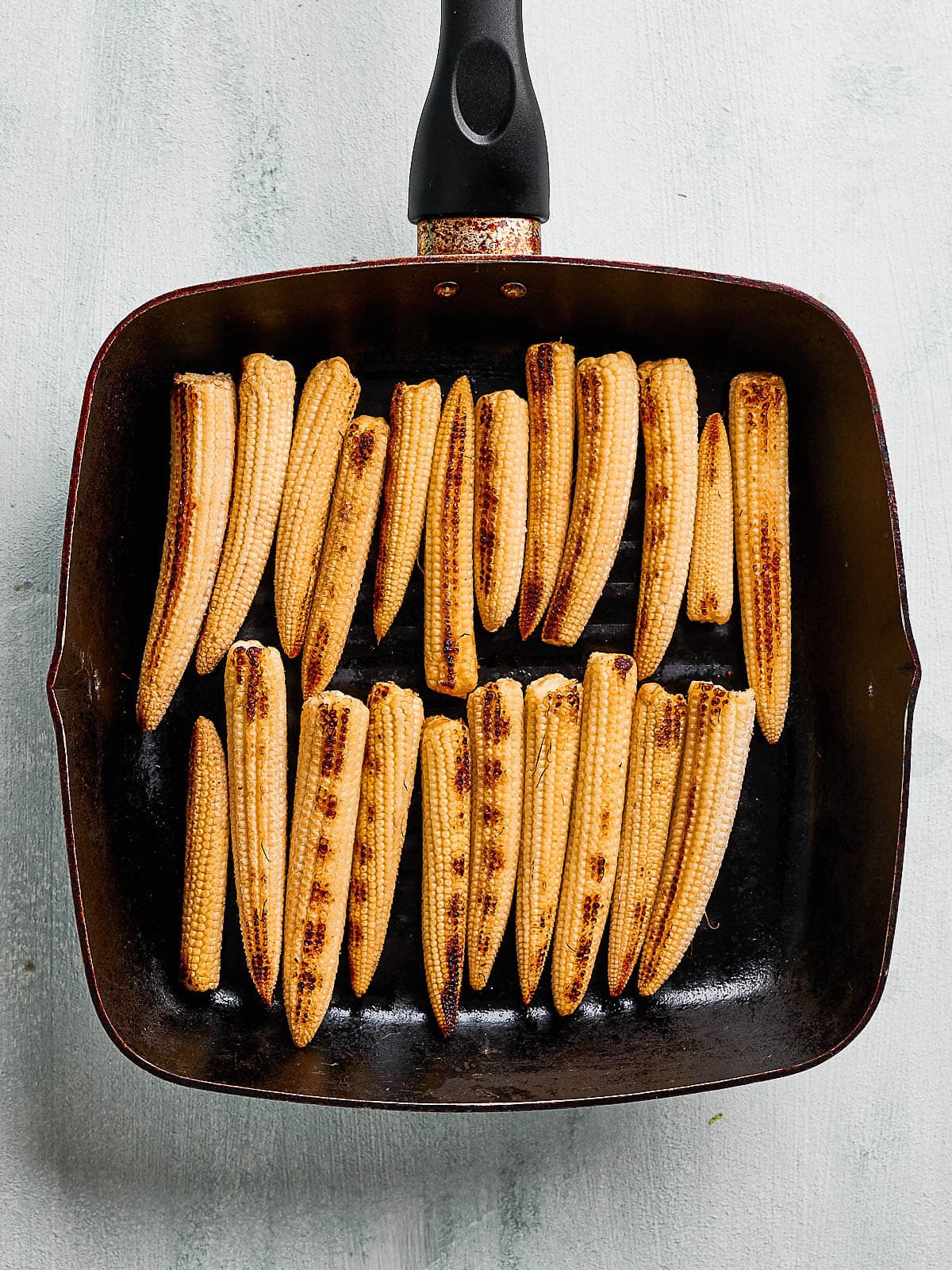 Baby corn in the griddle pan with char marks