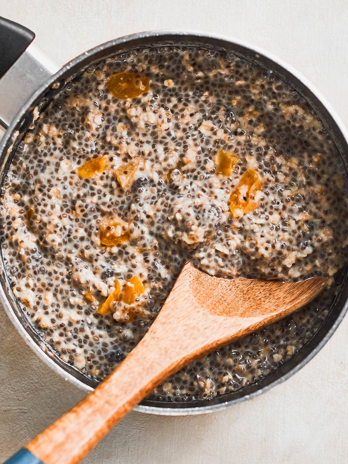 Chia seed porridge being stirred whilst cooking in the pan