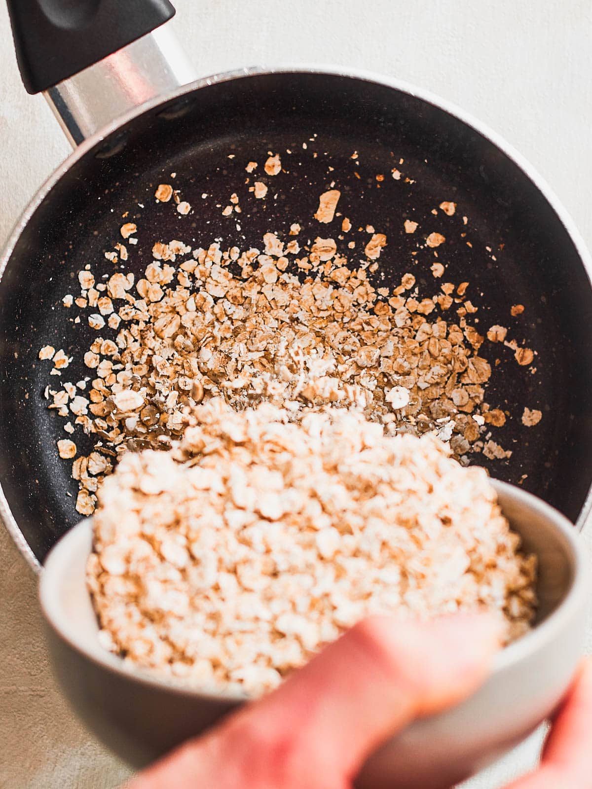 Tipping oats into saucepan