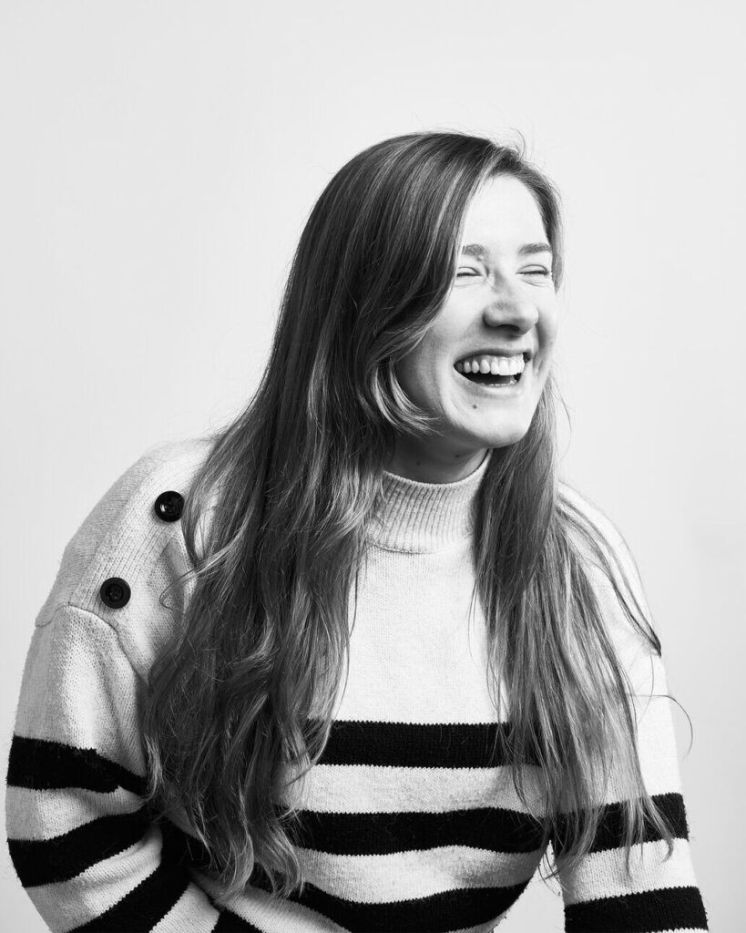 a black and white image of chloe laughing