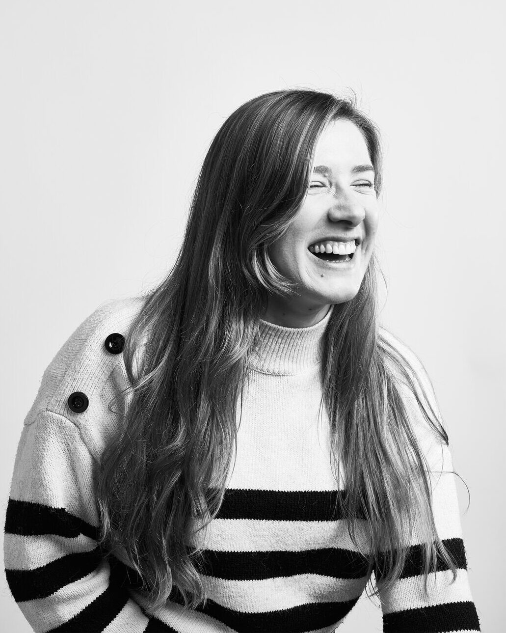 a black and white image of chloe laughing